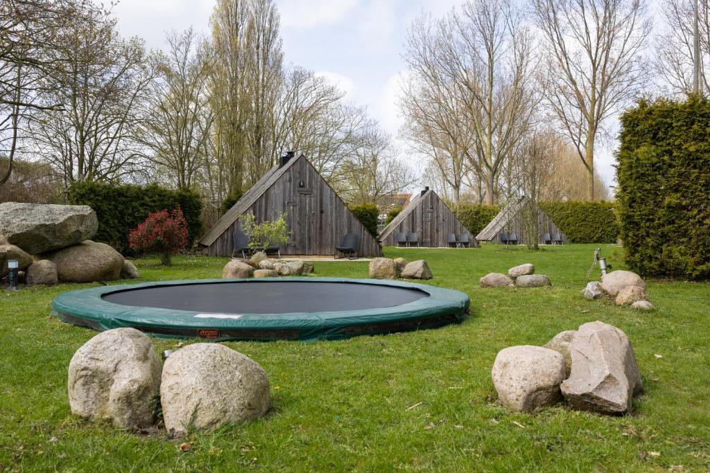 a small pool in the middle of a field with rocks at Back to Basic in Zwaanshoek