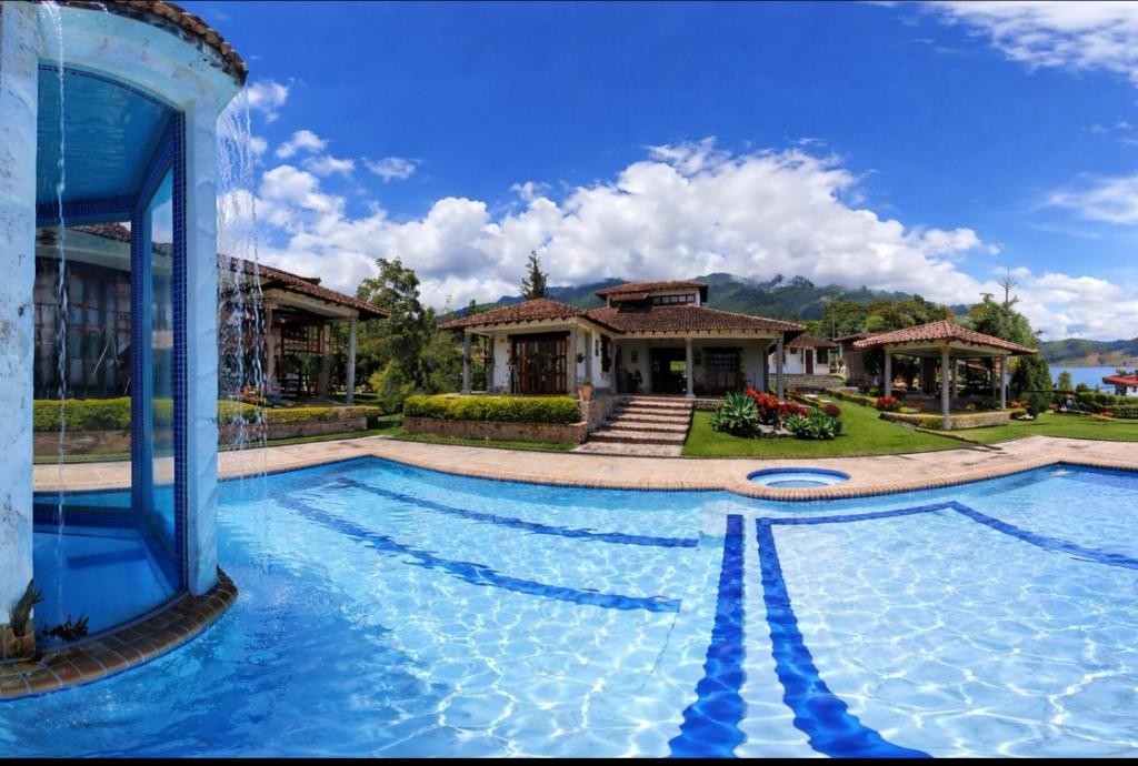a large swimming pool in front of a house at La Mona in Calima