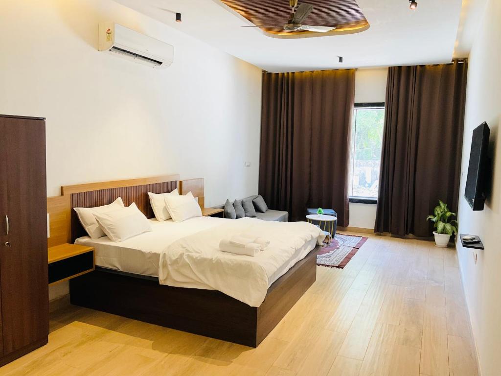 a bedroom with a large bed in a room at Origin Suites Luxury Boutique Hotel Pushkar in Pushkar
