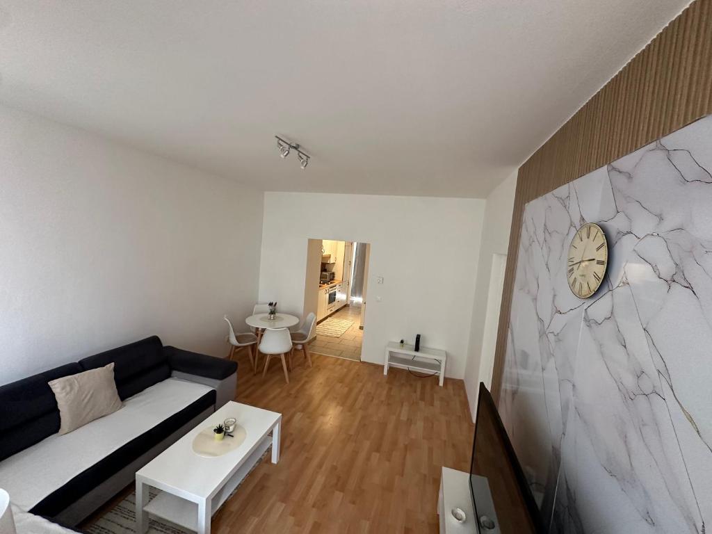 a living room with a couch and a table at Cozy Ground Floor Apartment Near U6 Easy Access to Center in Vienna