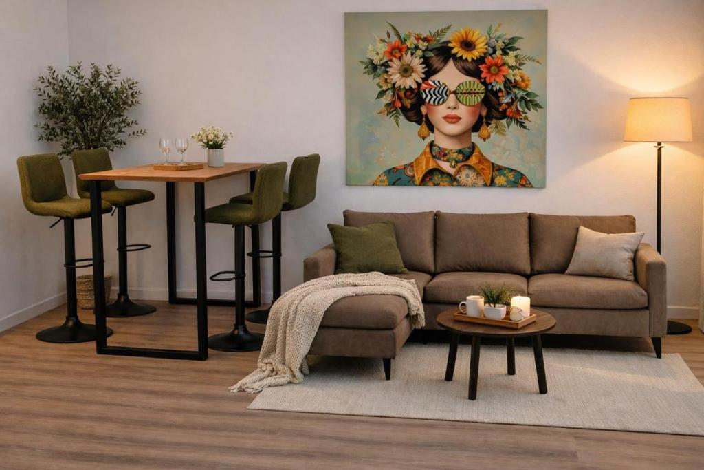 a living room with a couch and a painting of a woman at Veluwe Droom Chalet in Hoenderloo