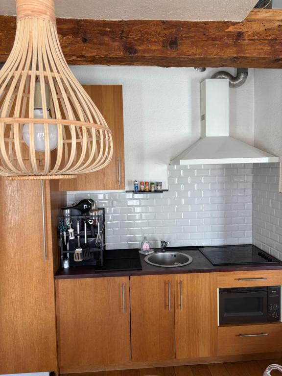 a kitchen with a sink and a microwave at Studio 1er Consul in Ajaccio