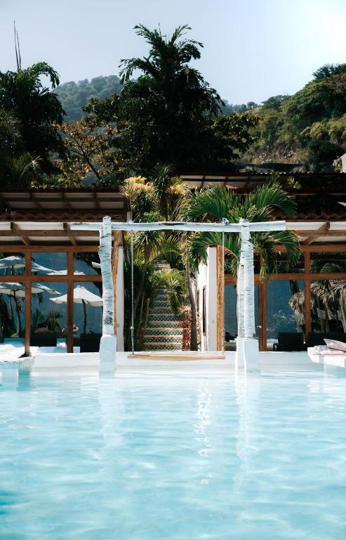 a view of a swimming pool with a pavilion at Sababa Resort in San Pedro La Laguna