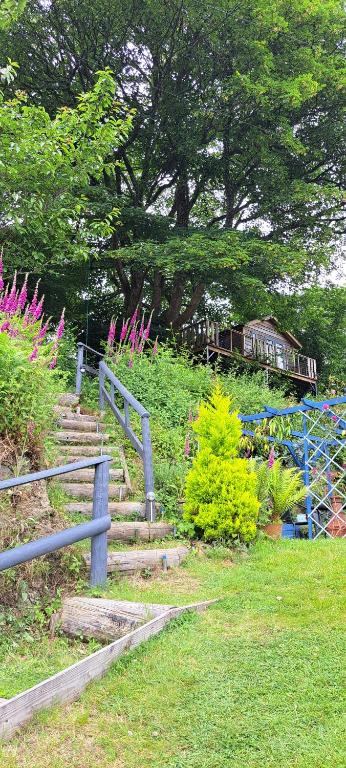 a set of stairs with a train in the background at Cosy Treehouse in Pontypool