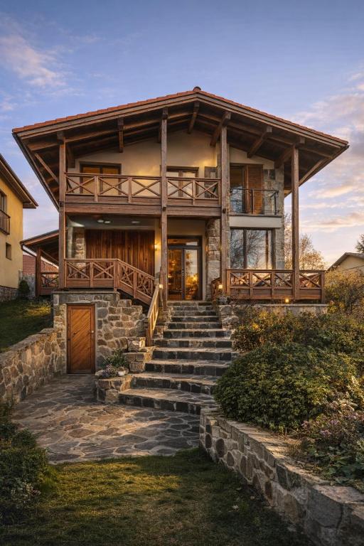 a house with stairs leading up to it at Villa Sofia - dovolenkový dom pre 8 osôb in Batizovce