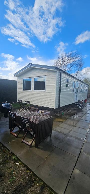 a mobile home with a picnic table in front of it at Sunny Haven in Skegness