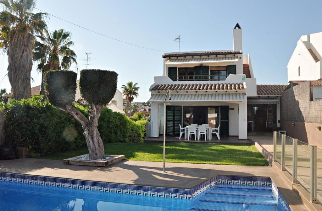 a house with a swimming pool in front of a house at Roda Bruc, casa con piscina privada! in Roda de Bará