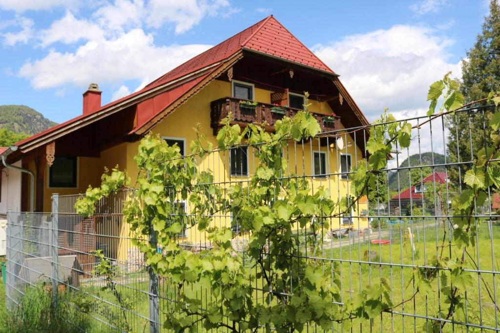an old yellow house with a red roof at Wagnermoosgut in Bad Ischl