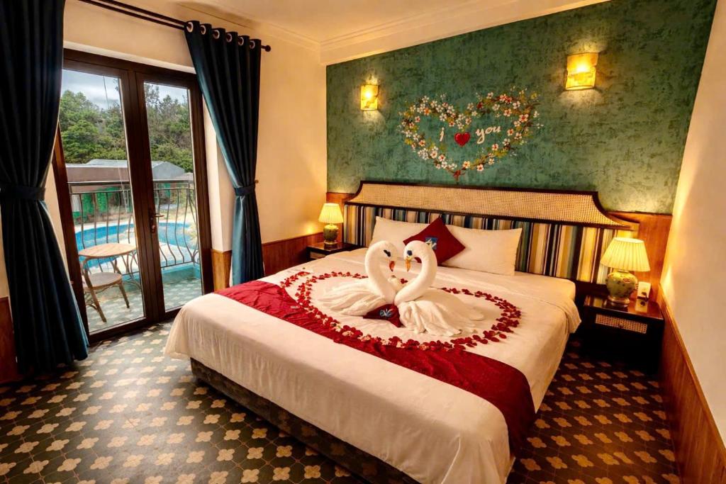 a bedroom with two swans in a bed at Minh Chau Beach Resort in Quang Ninh