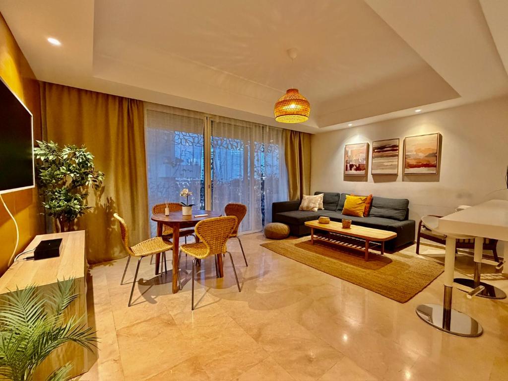 a living room with a couch and a table at Modern and cozy CFC apartment in Casablanca