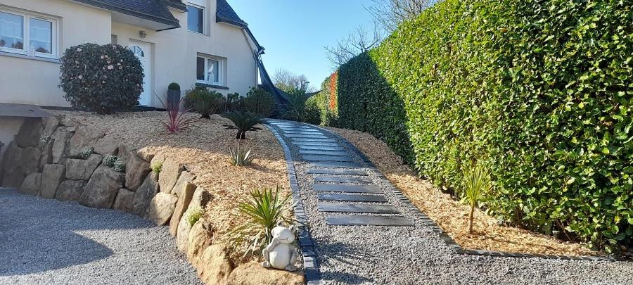 a garden with a toy train on a stone path at Au Bois Dormant in Monterblanc