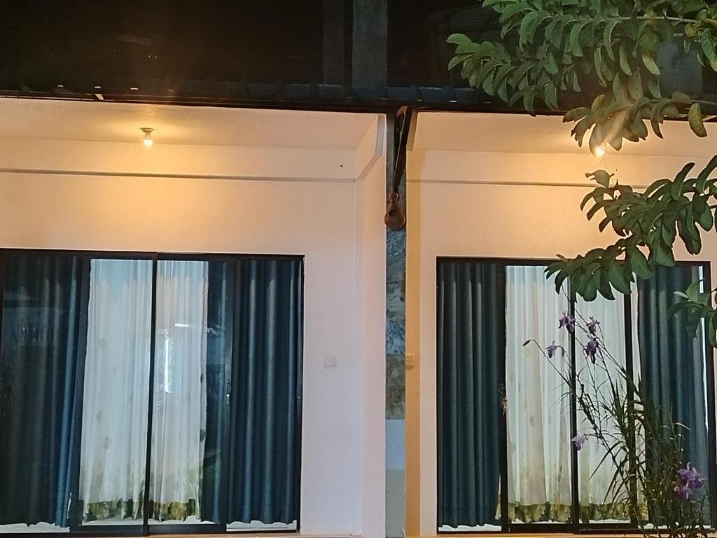 a pair of windows in a house at Phoenix Crest Cottage in Haputale