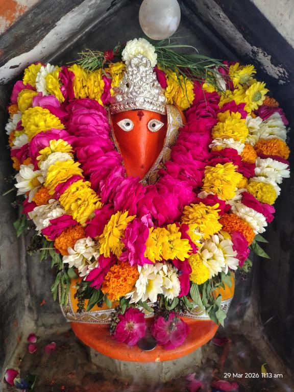 a large arrangement of flowers on top of a vase at आदिशक्ति भवन in Mirzāpur