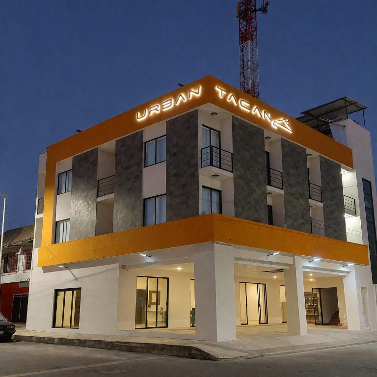 a building with a sign on top of it at Hotel Urban Tacana in Tapachula
