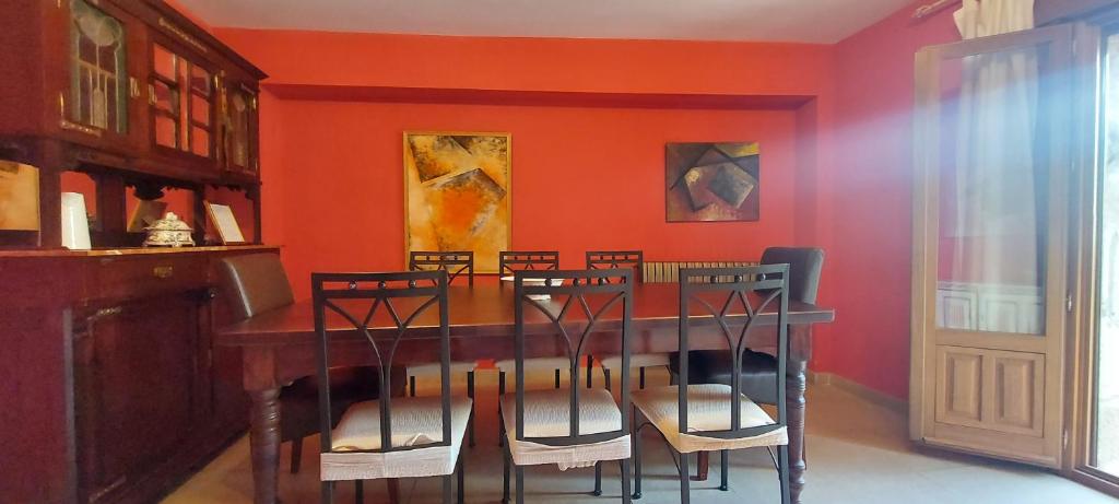 a dining room with a table and chairs at La Casa de la Huerta in Vinuesa