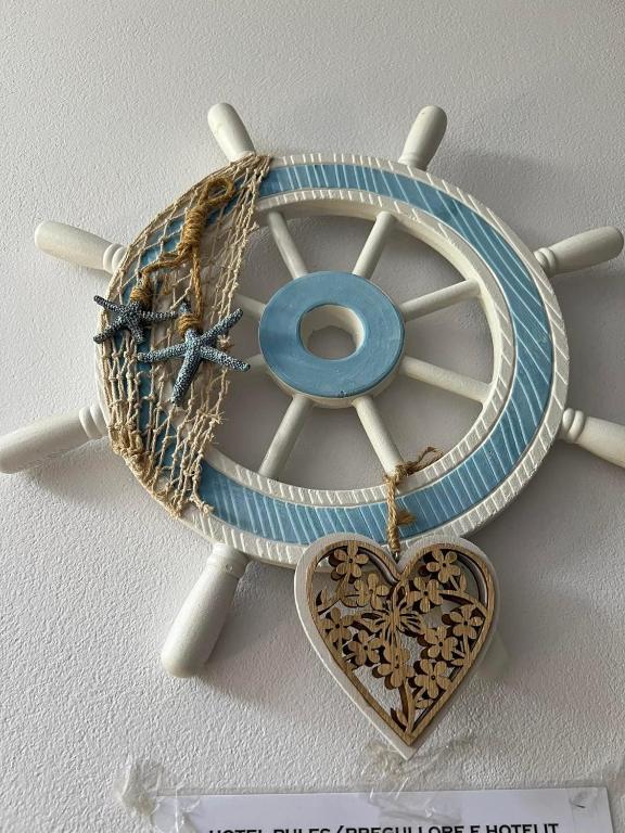 a wooden wheel with a heart next to it at Meta apartment in Ksamil