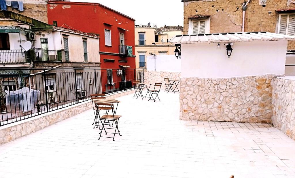 a patio with chairs and tables on a building at Terrazza Cristallini Napoli in Naples