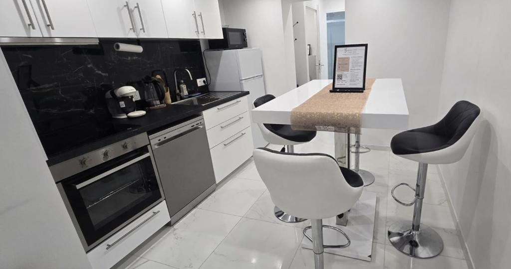 a kitchen with a counter and a table and chairs at Chez Bio in Coulommiers