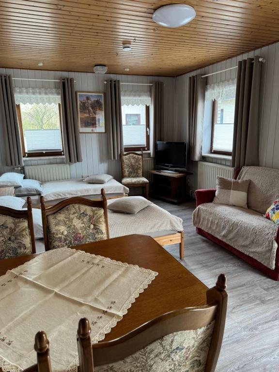 a living room with two beds and a couch at Weesby Süderstraße 3.3 in Weesby