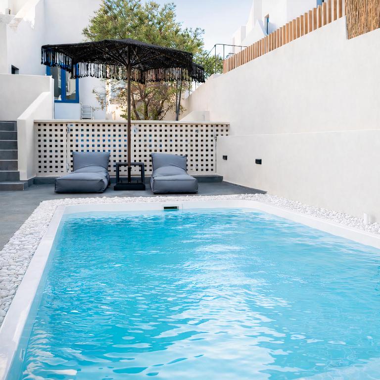 a swimming pool in the backyard of a house at Aidani Luxurious Rooms in Vóthon