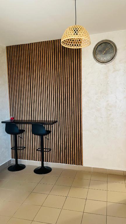 a bar with two stools and a wooden wall at Panorama - 2 Lazarevac in Lazarevac