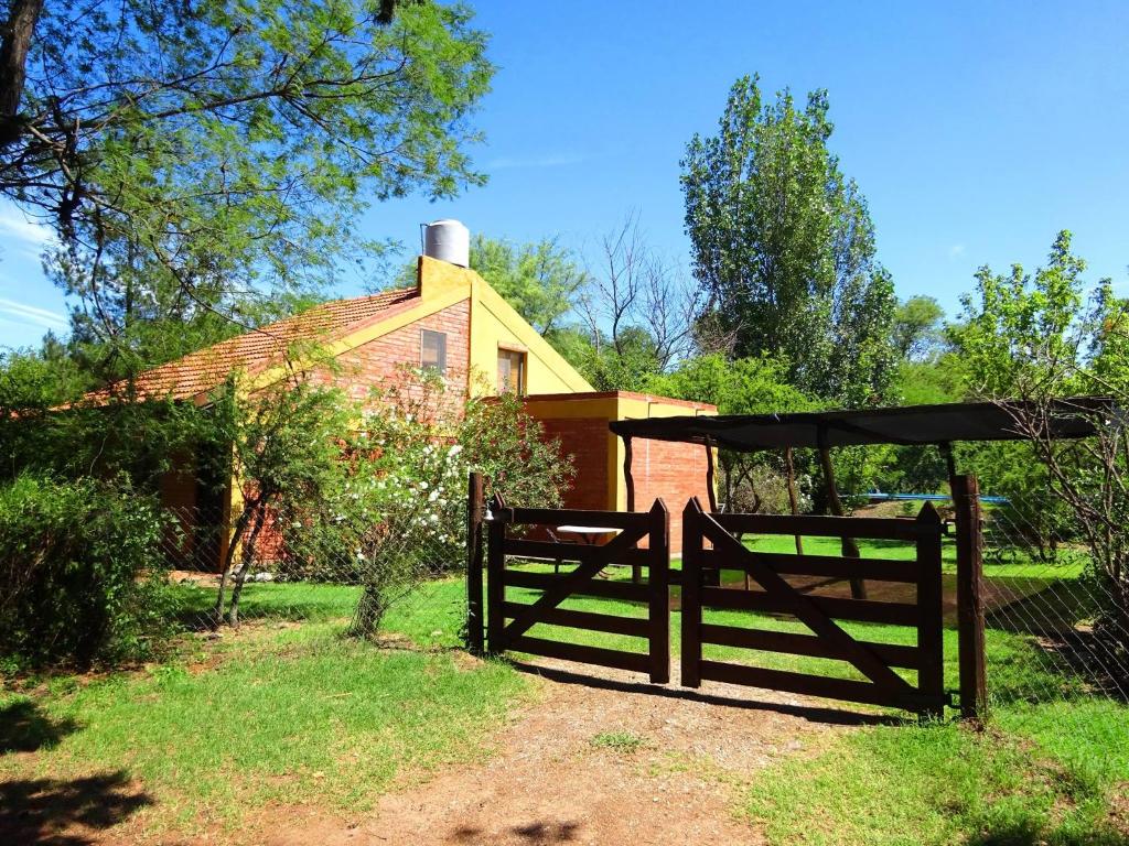 a wooden fence in front of a house at Cabañas Desde Las Estrellas in Merlo