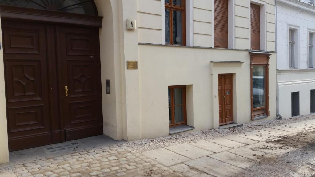 two brown doors on the side of a building at Appt Berlin in Berlin