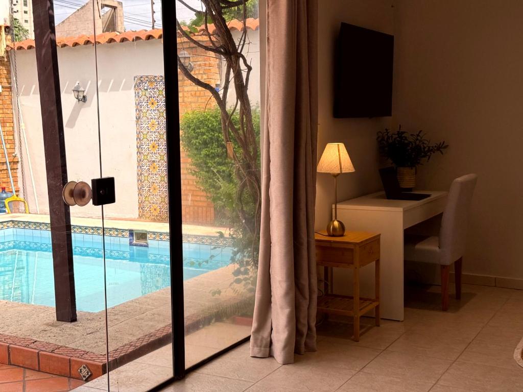a living room with a view of a swimming pool at Casa KOMU in Asunción