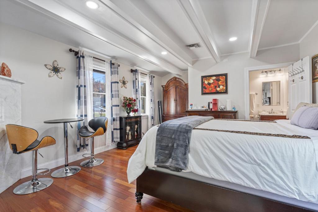 a bedroom with a bed and a table and chairs at National Harbor Suite 1 in Fort Washington