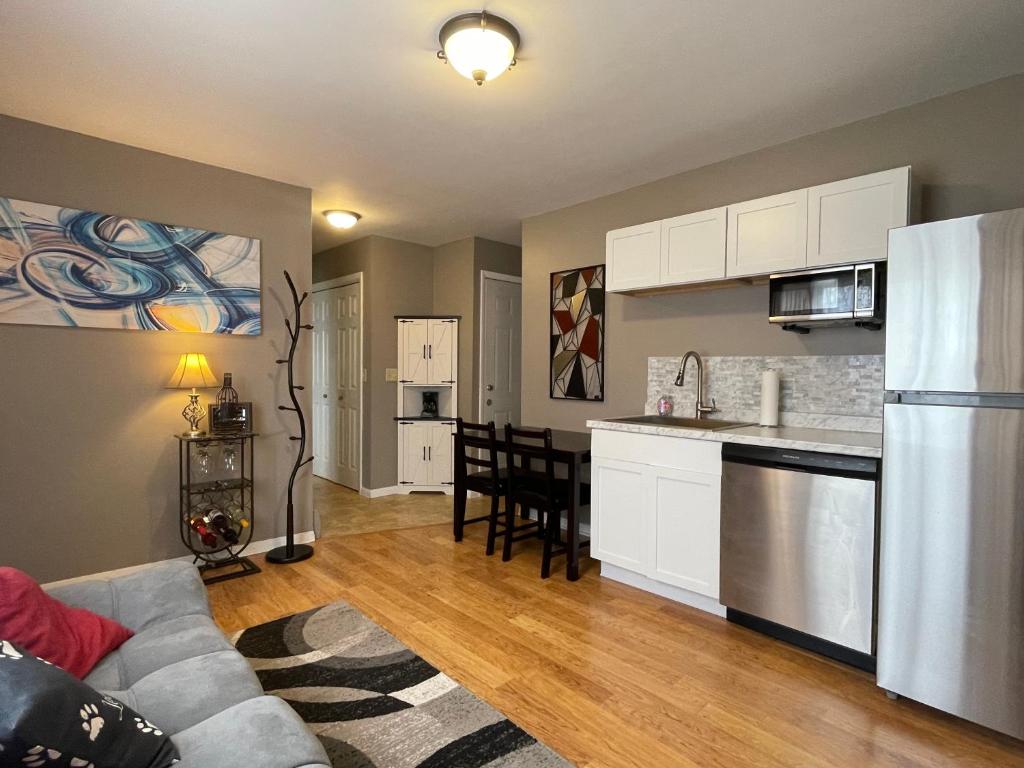 a living room with a couch and a kitchen at Private king suite in Dubuque
