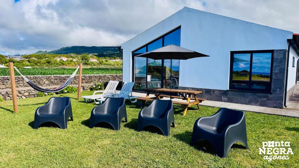 a blue house with a picnic table and chairs at Beer House by PontaNegraAzores in Altares