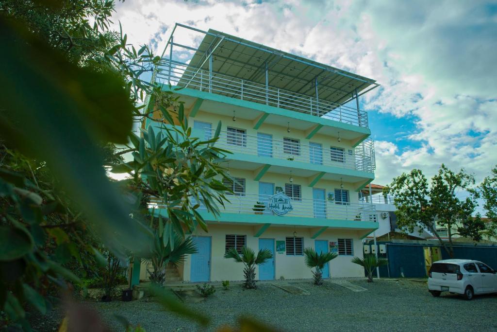 a white building with a solarium on top of it at Hotel Anedi in Concepción de La Vega