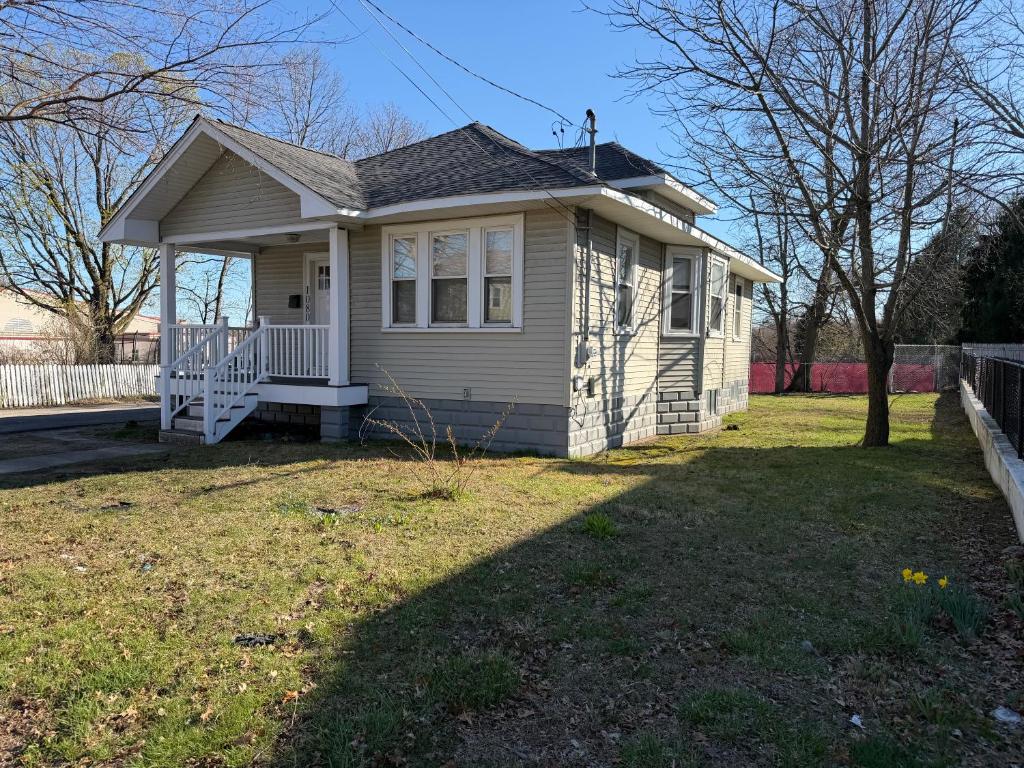 a small house with a lawn in front of it at Providence Cozy Stays in Providence