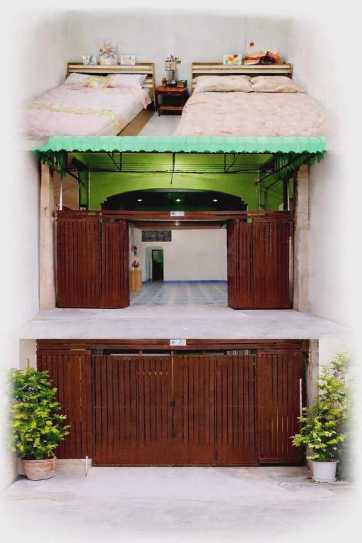 a large room with two beds and two potted plants at BS myhome in Sathani Hat Yai
