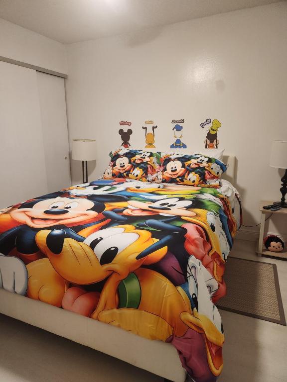 a bedroom with a hello kitty comforter on a bed at 2 Cute 2 Pass UP in Orlando