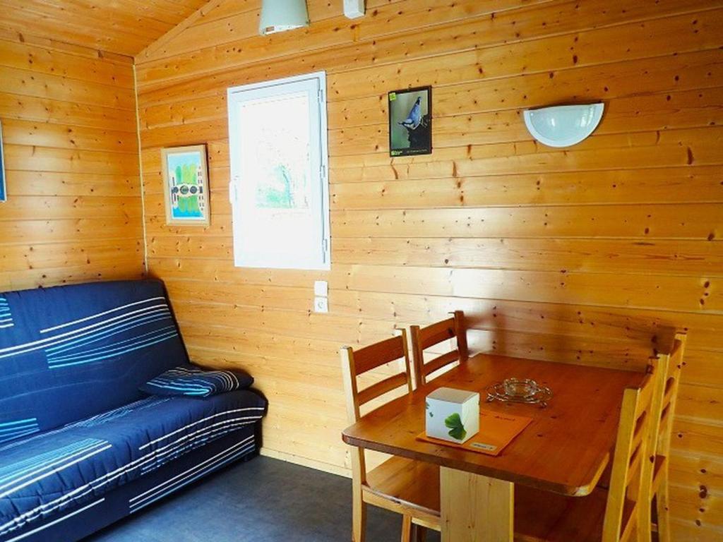 a room with a couch and a table in a cabin at Chalet accueillant - 4 pers. - API-1-52-2453 in Meyrueis