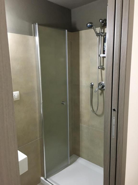 a shower with a glass door in a bathroom at Annette Rooms in Bari