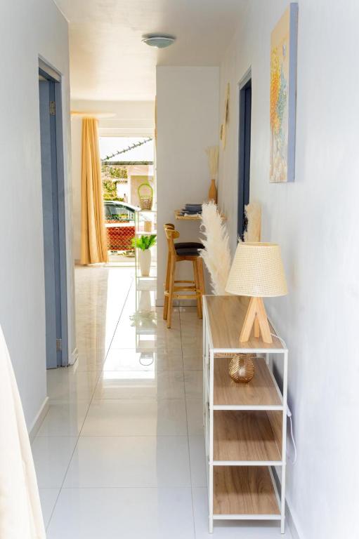 a hallway with a table with a lamp on it at Maysi apartments in Willemstad