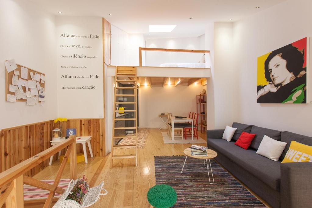 a living room with a couch and a table at Alfama Fado Loft in Lisbon