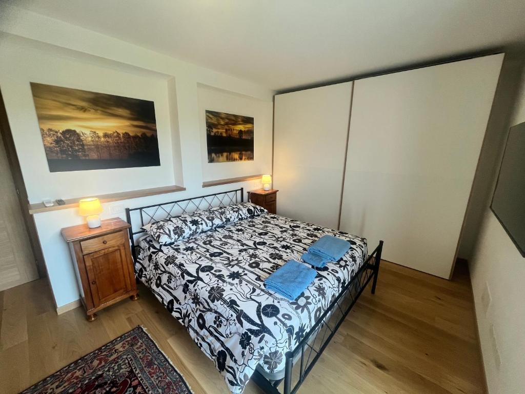 a bedroom with a bed and a night stand with two lamps at Quercia al Fiume in Ragogna