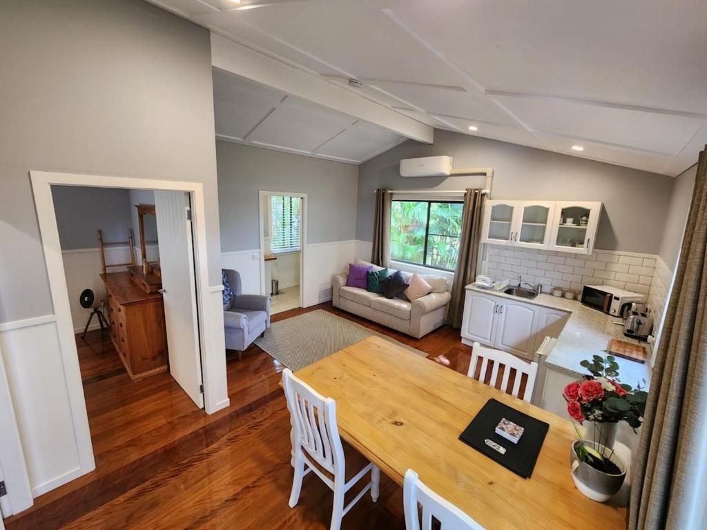 a kitchen and living room with a table and chairs at Hillside Hideaway - Your Base for the Region in Cawongla
