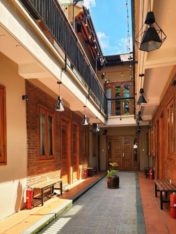 a courtyard with benches and a staircase in a building at Sun Nova Home Phu Quoc in Phú Quốc