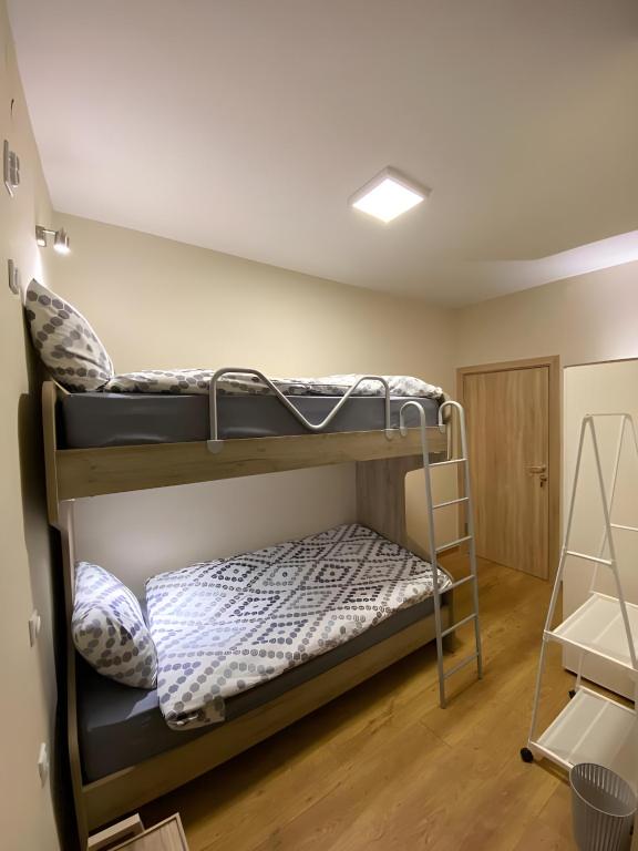 two bunk beds in a room with a ceiling at Atlas Hostel in Skopje