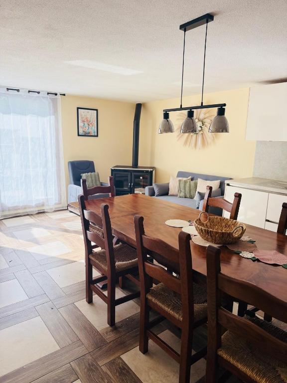 a dining room and living room with a table and chairs at Appartamento Aurora in Orosei