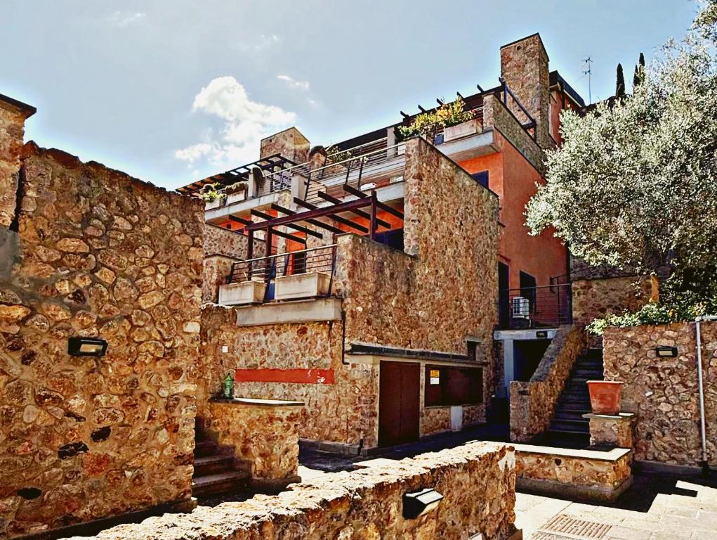 an old stone building with stairs in front of it at Villa La Terrazza in Porto Santo Stefano