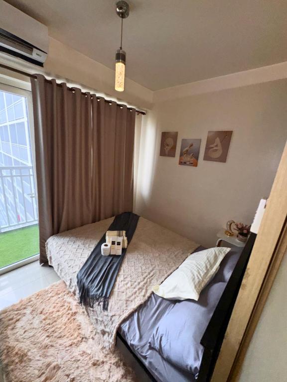 a bedroom with a bed with a cross on it at Velour Suites in Manila
