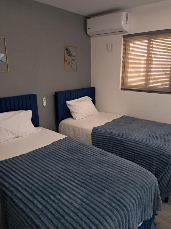 a room with two beds and a window at Small Cozy Rest #8 Efficiency in South Bimini