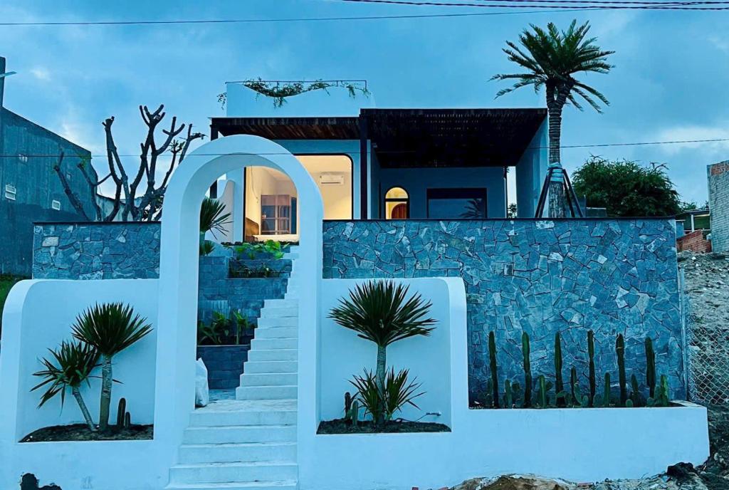 a house on the beach with a stone wall at Changvilla Đông Hải in Thôn Ðông Giang