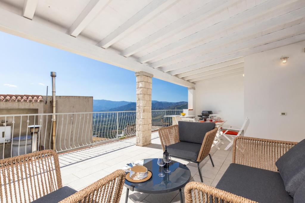 a patio with a table and chairs on a balcony at Appartamento La terrazza in Baunei