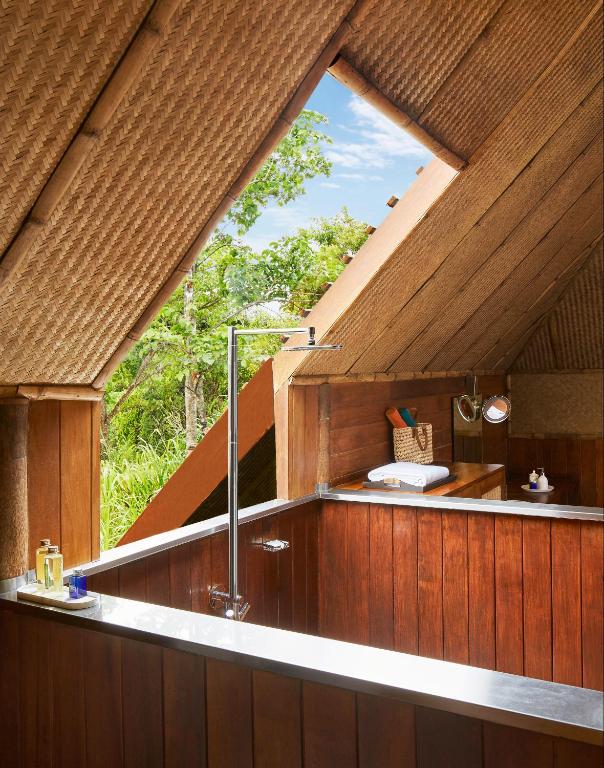a room with a large window in a house at Jetwing Vil Uyana, A Luxury Reserve in Sigiriya